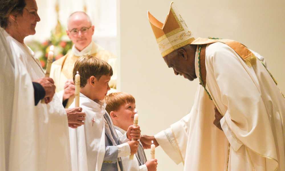 Bishop Fabre-Jeune smiling at children