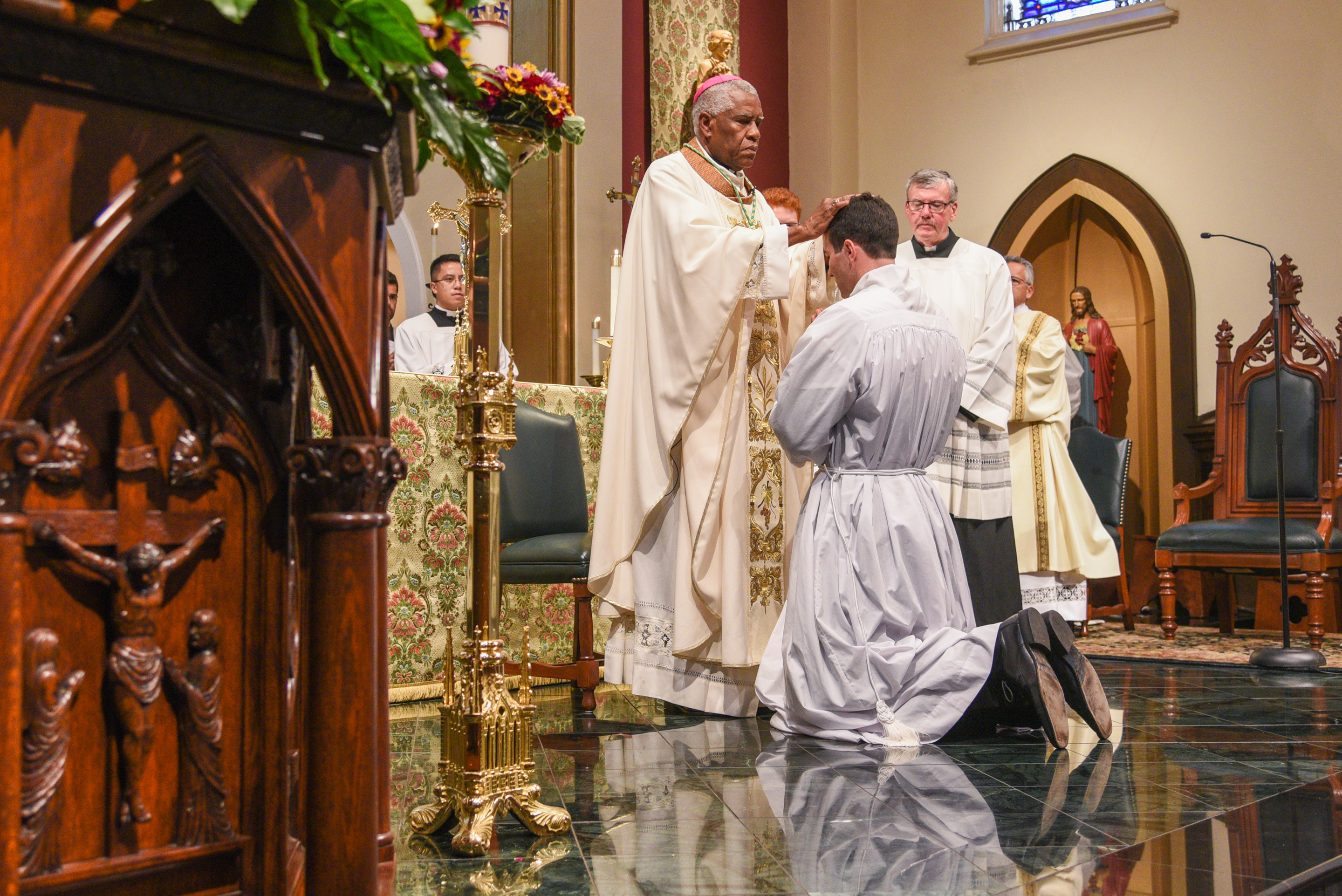 Bishop Fabre-Jeune laying hands upon Deacon Peter O'Steen