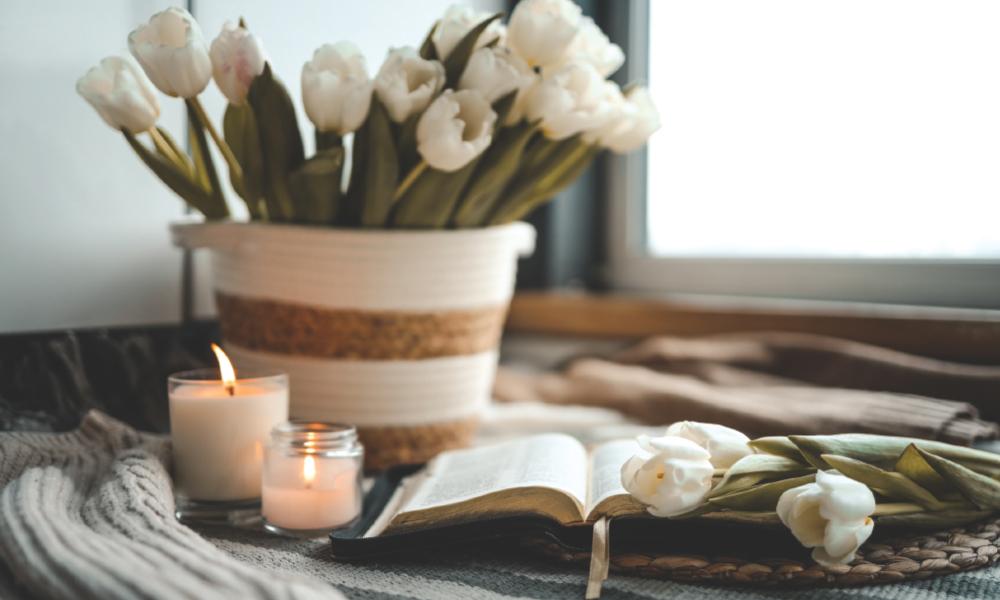 White tulips and candles with a bible
