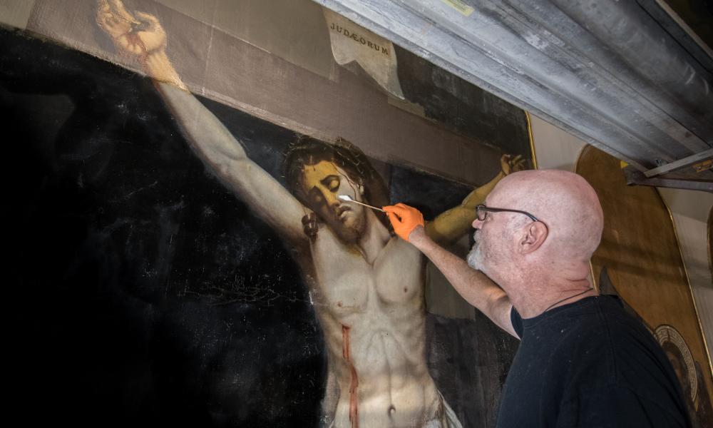 Craig Crawford works on art restoration at St. Mary
