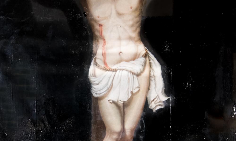 Close-up of crucifixion art mid-restoration