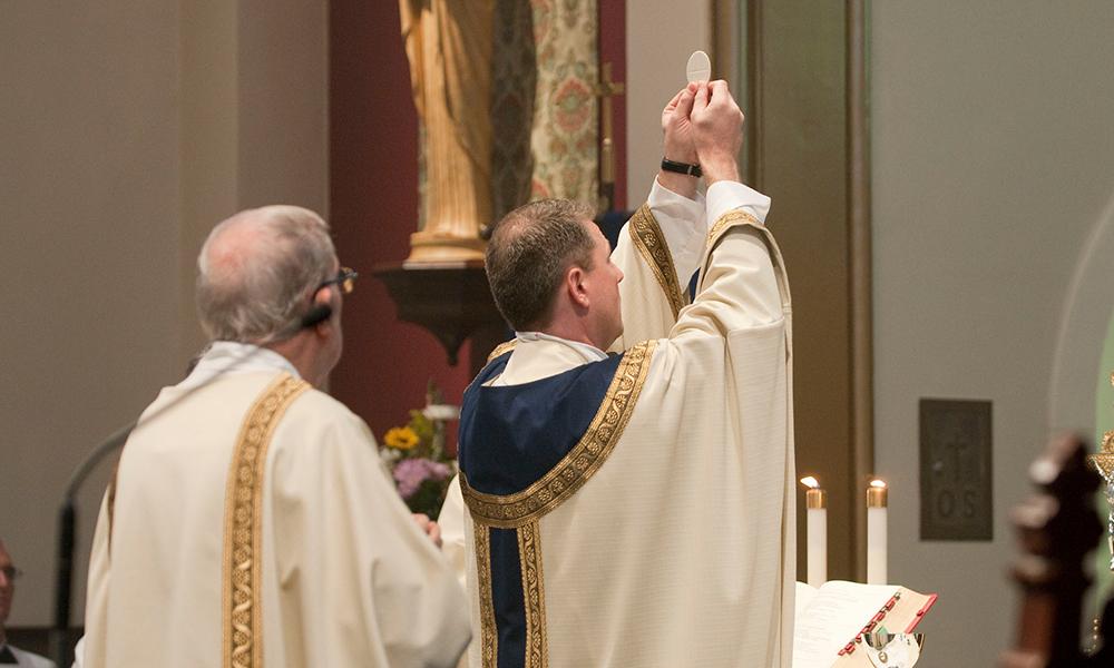 Priest presenting the Eucharist