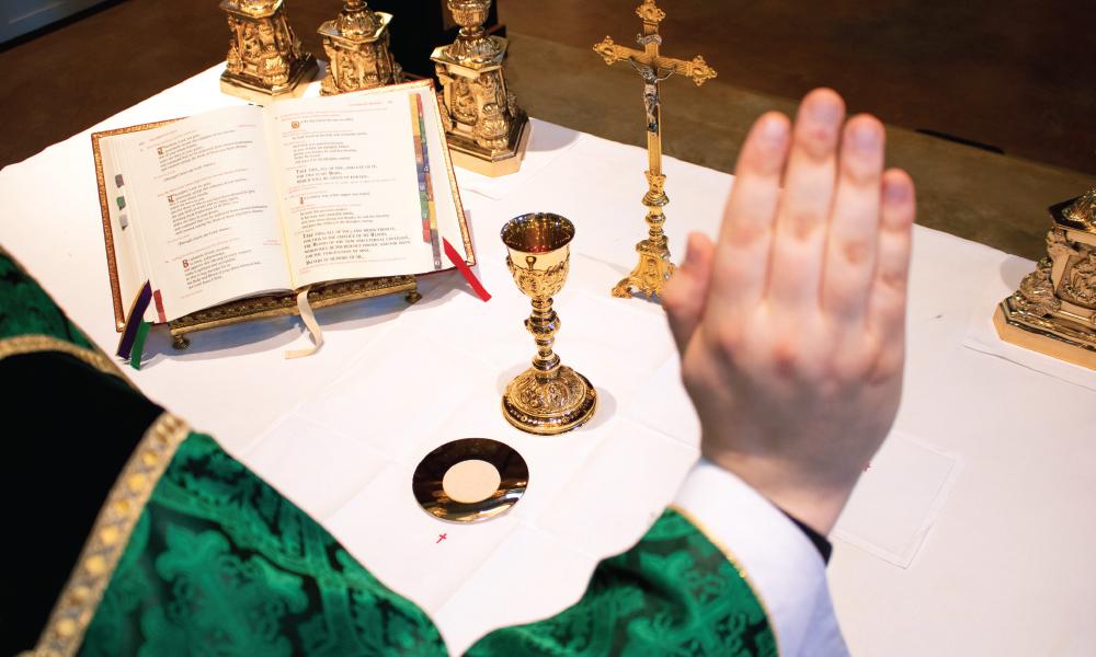 Priest consecrating the Eucharist