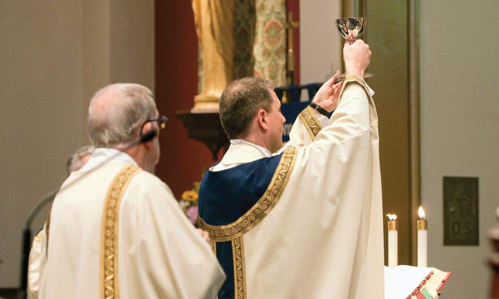 Priest presenting the Blood of Christ