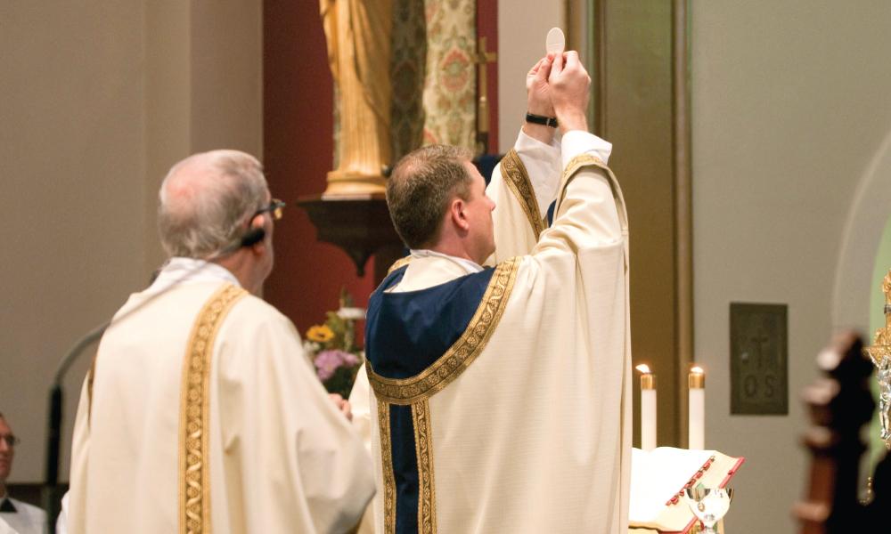 Priest presenting the Eucharist