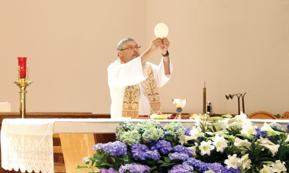 Priest presenting the eucharist