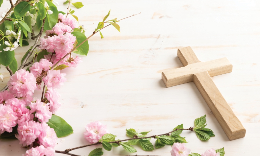 Cross with pink flowers and greenery