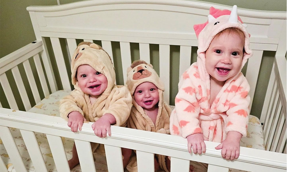 The Raad kids in a crib