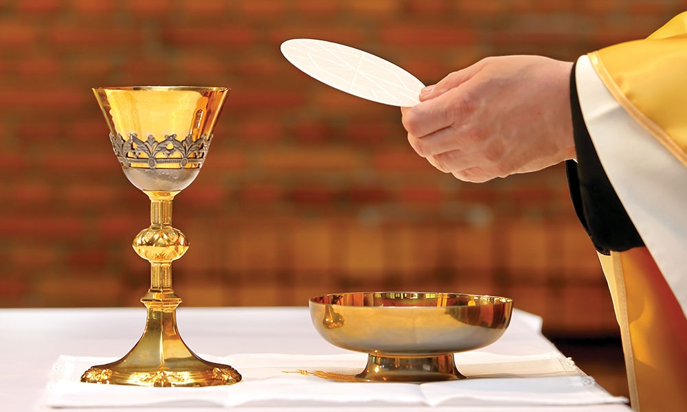Priest holding the Eucharist