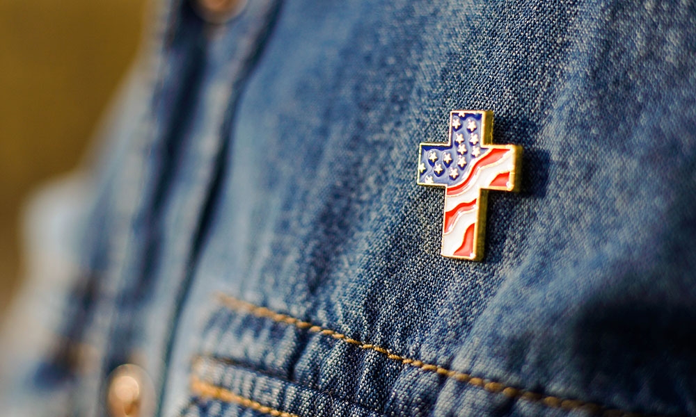 Patriotic cross pin on a jean jacket