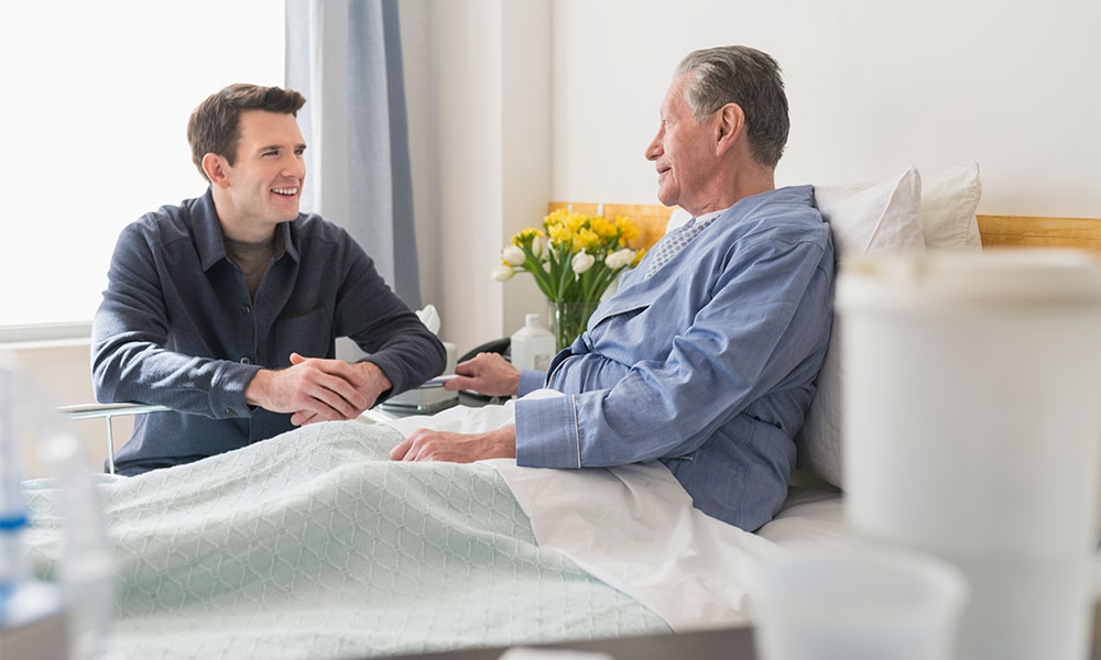 Image of people in a hospital room talking