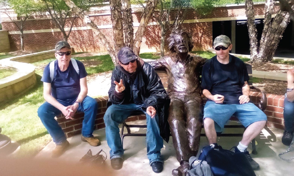 Laughlin McCoy, at left, sits with Leif and George, men experiencing homelessness in South Carolina.
