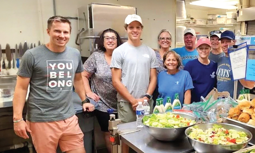 Volunteers at New Directions shelters making meals in a kitchen