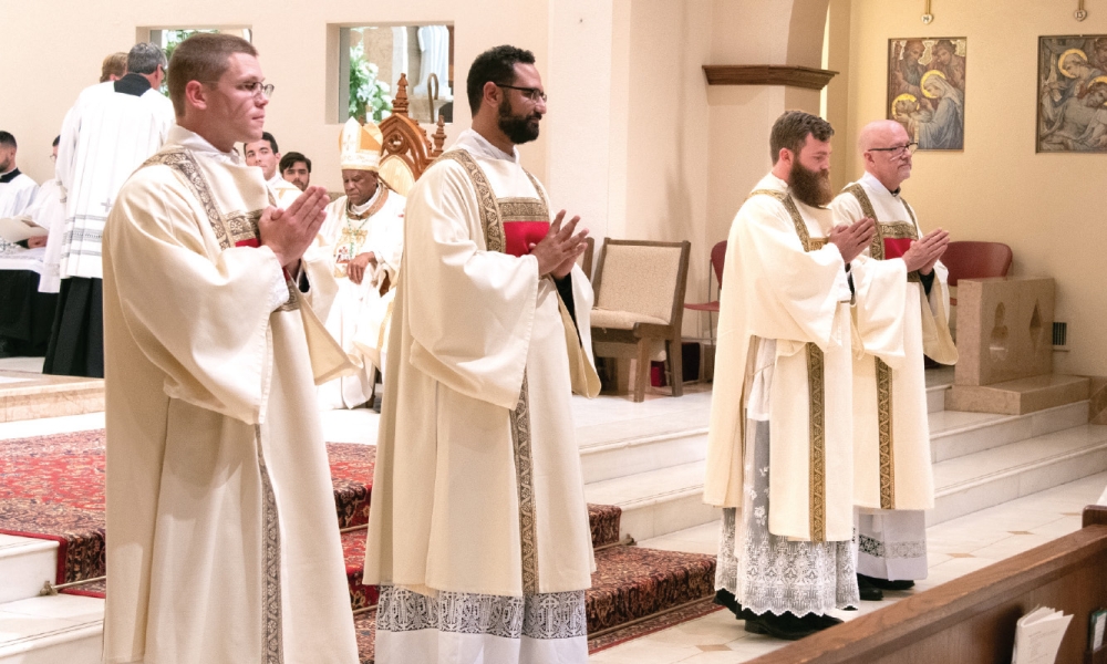 Four ordained transitional deacons