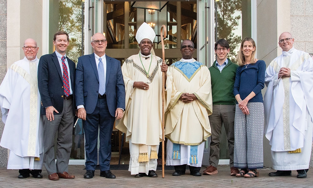 From left to right are Rev. Msgr. D. Anthony Droze, vicar general; Dr. Colin Edgerton, guild vice president; Dr. Tom McNamara, president; Bishop Jacques Fabre-Jeune, CS; Father JohnBosco Ikemeh, guild chaplain; Dr. Brendan Neary; Dr. Amy Dietrich, guild secretary; and Very Rev. Gregory B. Wilson, vicar general.