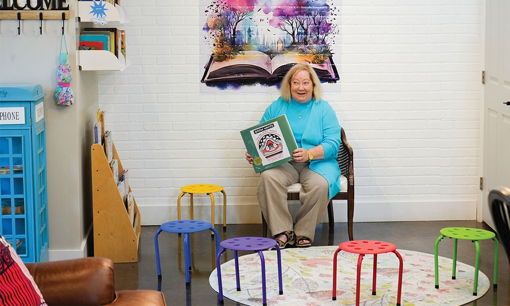 Jan Parmenter holding a book in Spotlight Books