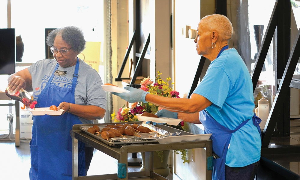 Two women working a soup kitchen