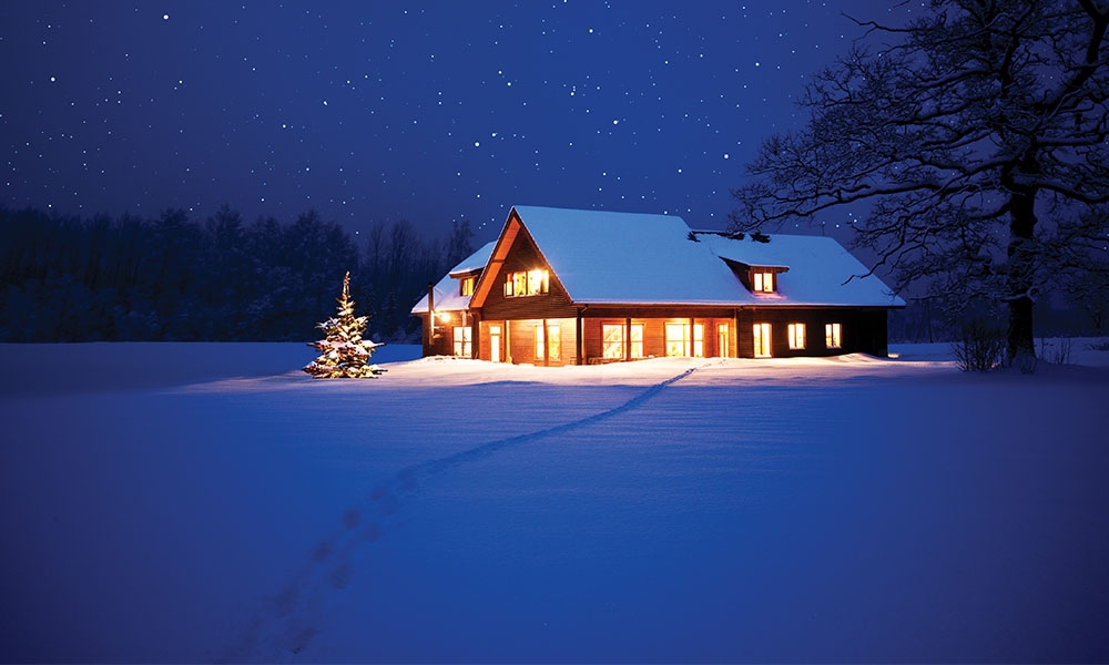 Snowy cabin at night