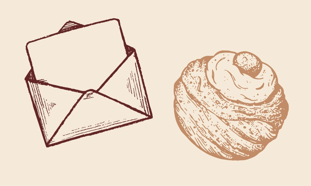 Illustrated letter in an open envelope and a pastry