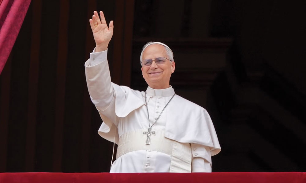 Pope Leo XIV waves to the crowd from the central balcony of St. Peter's Basilica at the Vatican