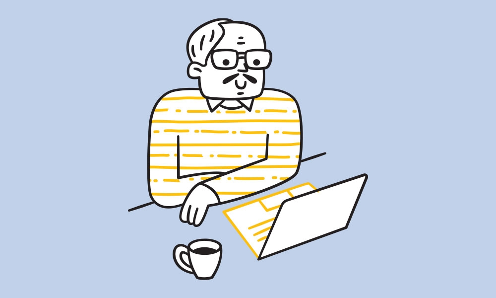 Older man sitting at a laptop with a cup of coffee