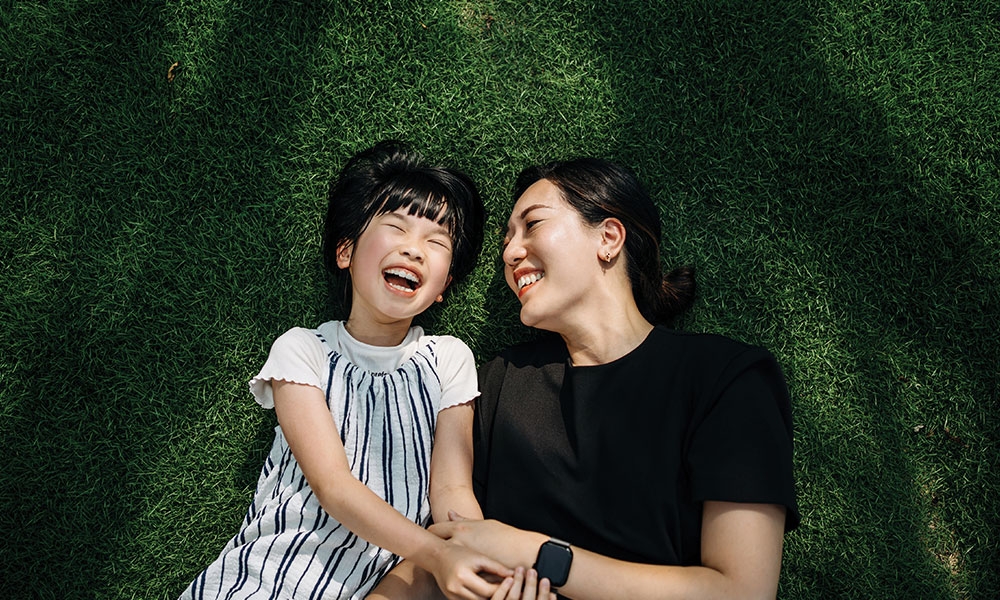 Mother and daughter laughing together