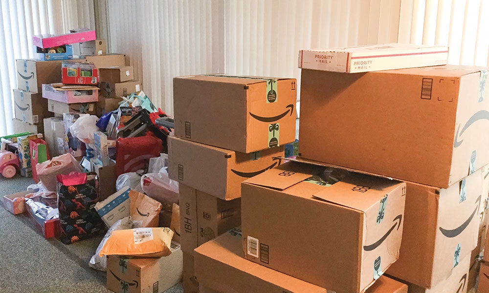 An image of lots of boxes and bags along a wall