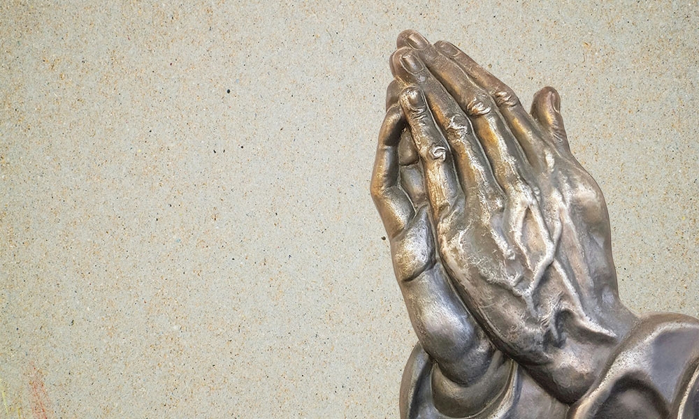 Image of bronze praying hands