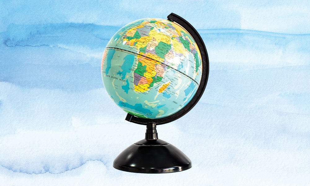 Image of a globe in front of a watercolor blue background