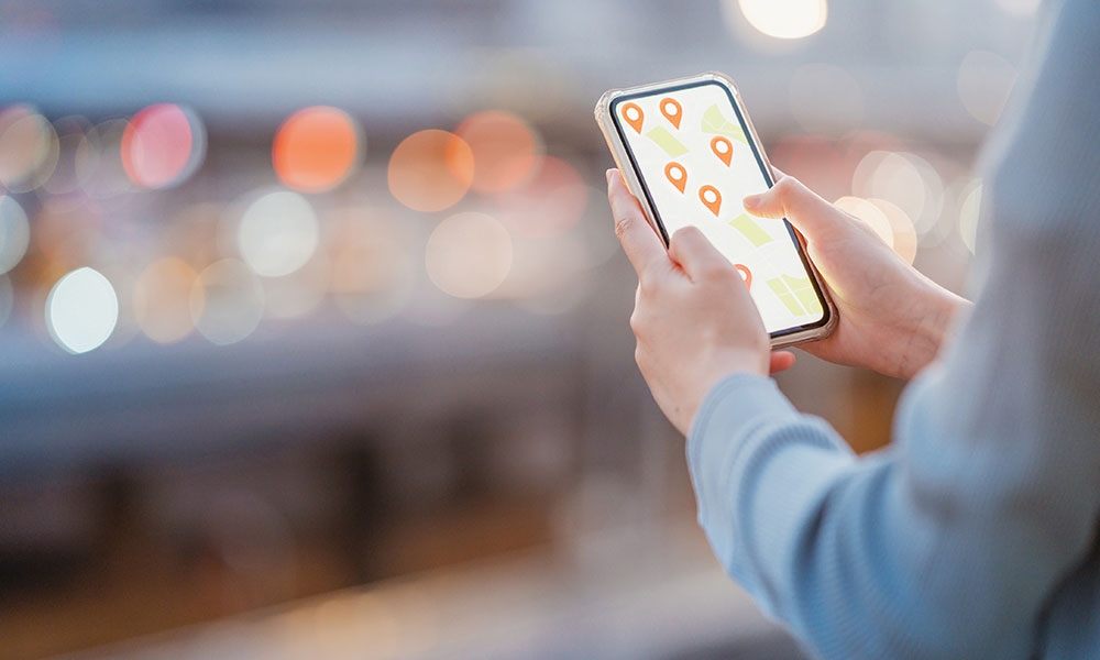 Person holding a phone looking at a map